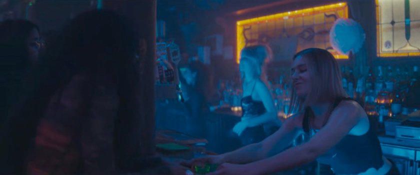 Bartender at club serving shots.