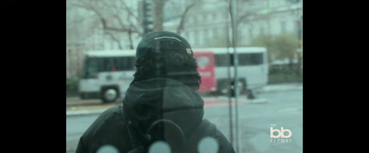 BB Report: man in enclosed bus stop.