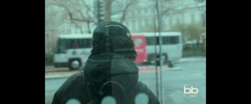 BB Report: man in enclosed bus stop.