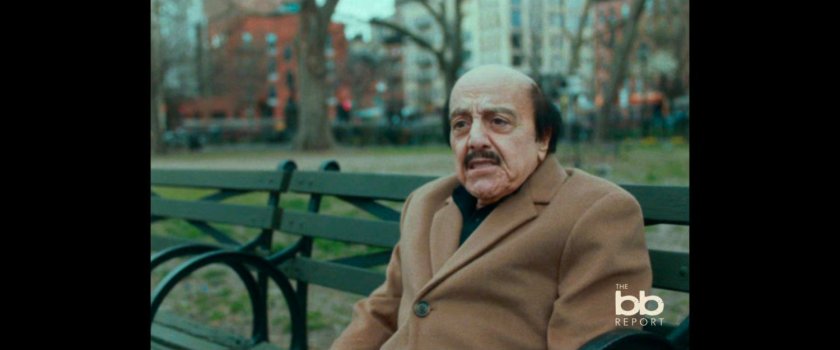 BB Report: man interviewed on park bench.