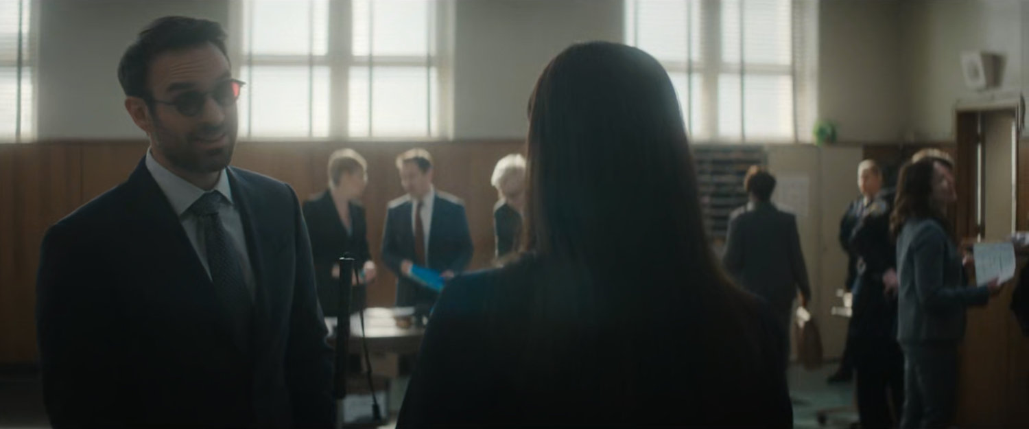 Matt speaking with Sofija in the city courtroom.