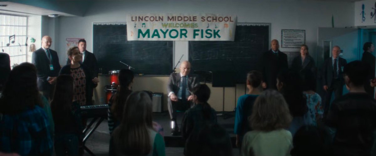 Mayor Fisk listens to a children's choir at Lincoln Middle School.