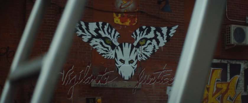 Interstitial: White Tiger 'vigilante justice' graffiti.