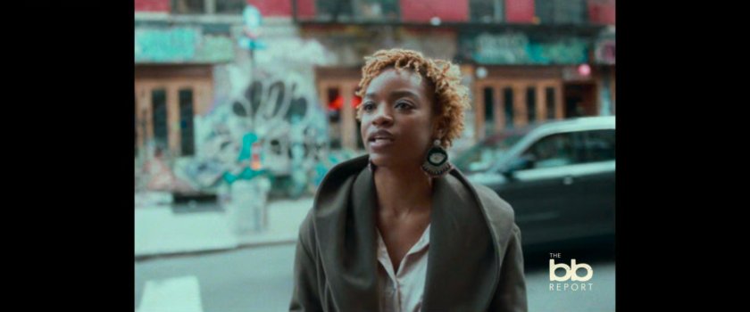 BB Report: woman interviewed on sidewalk.