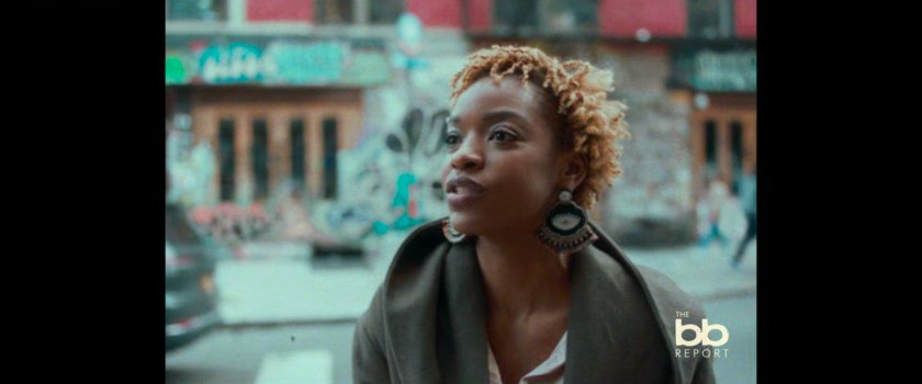 BB Report: woman interviewed on sidewalk.