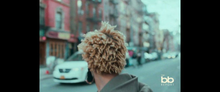 BB Report: woman interviewed on sidewalk.