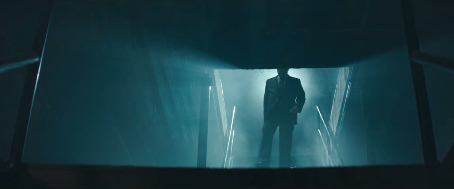 Fisk descends stairs, backlit.