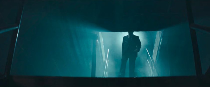 Fisk descends stairs, backlit.