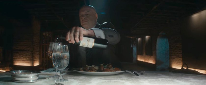 Fisk dining at a table in his dungeon.