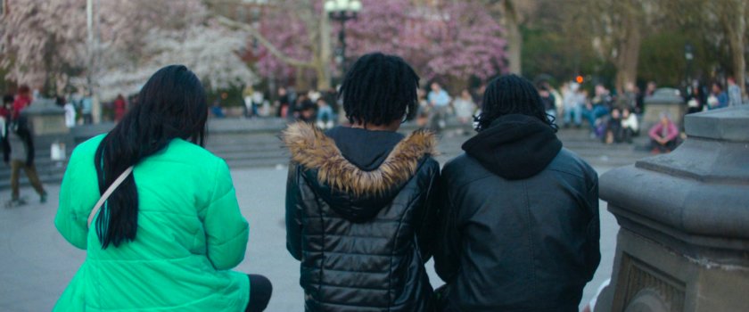 Interstitial: trio sitting in a park.