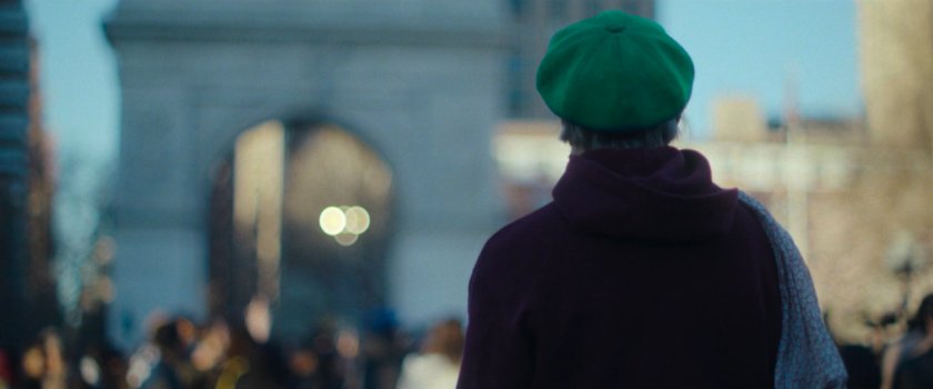 Interstitial: Woman siting near Washington Square Arch.
