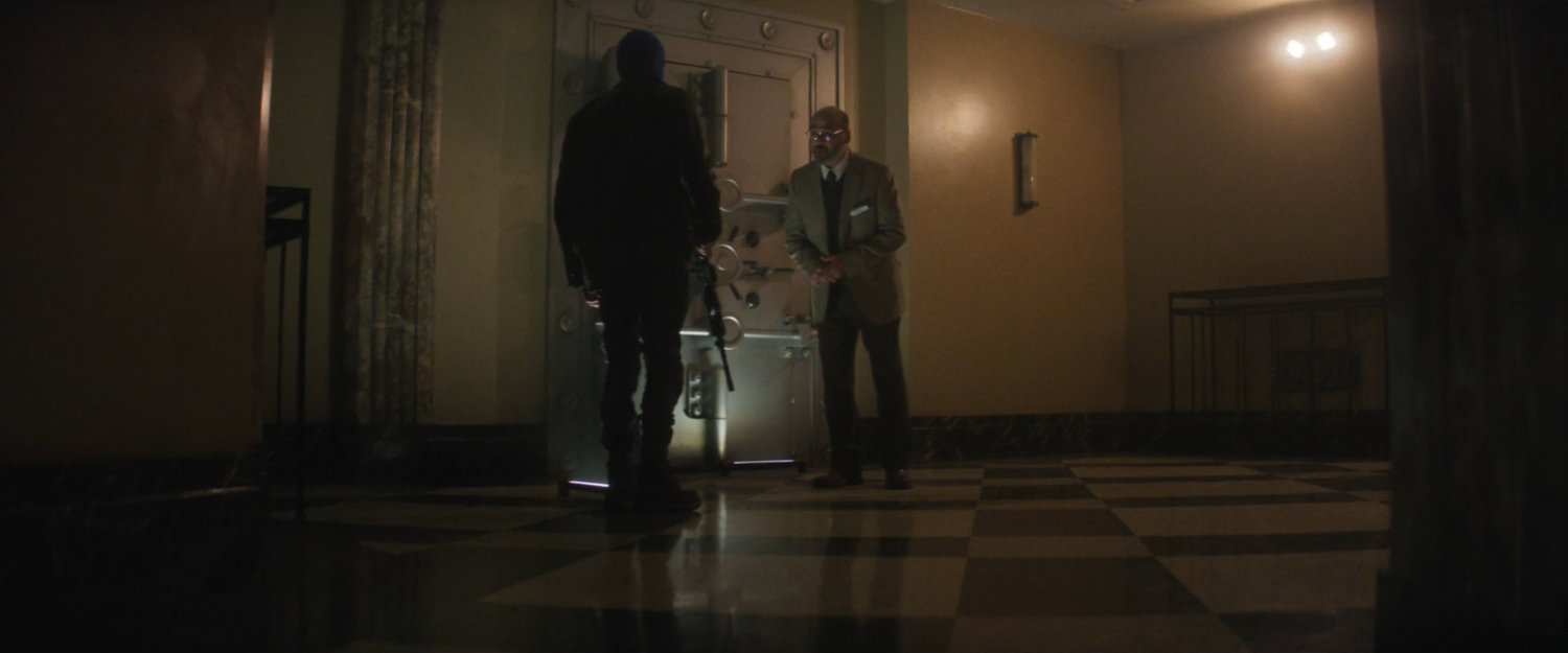 Robber and Yusuf outside vault in New York Mutual Bank.