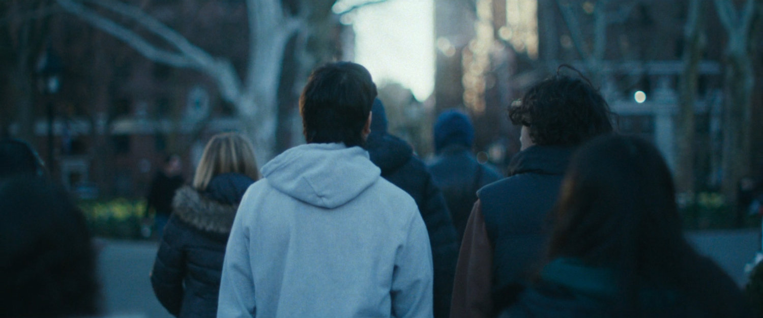 Interstitial: people walking through park.