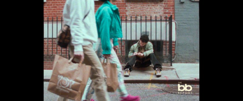 BB Report: man sitting on sidewalk.