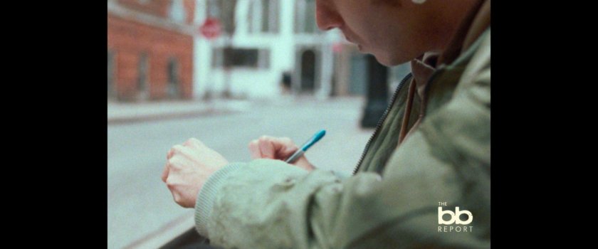 BB Report: man writing in journal.