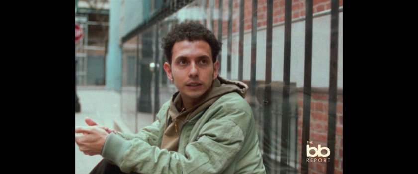 BB Report: man interviewed sitting on sidewalk.