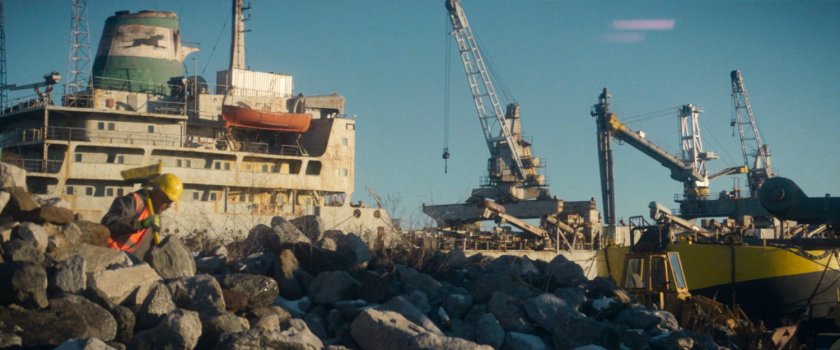 Sanitation worked on rocky shore near Red Hook port.
