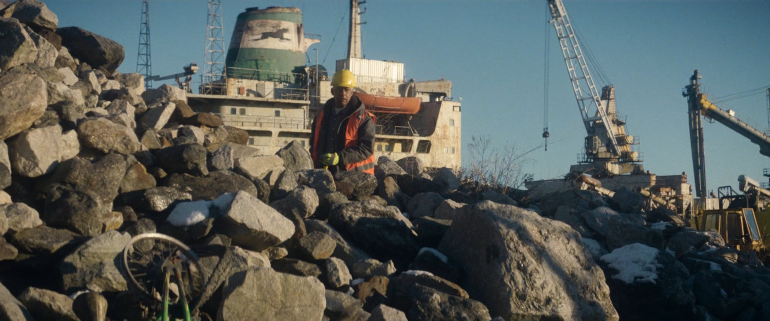 Sanitation worked on rocky shore near Red Hook port.