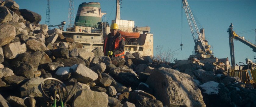 Sanitation worked on rocky shore near Red Hook port.