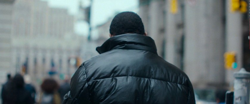 Interstitial: man on street with out of focus buildings.