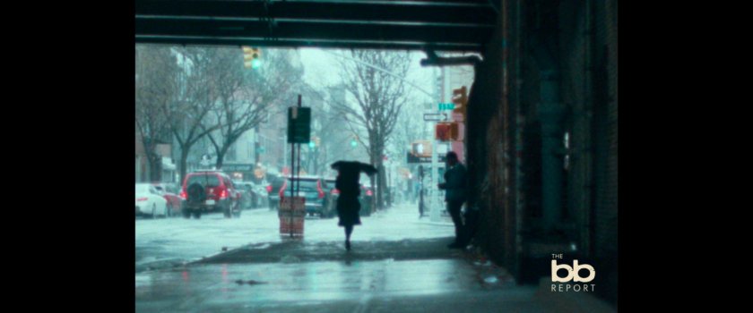 BB Report: person with umbrella walking through an underpass.