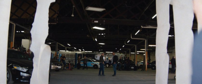 Plain clothes police officers in police garage.