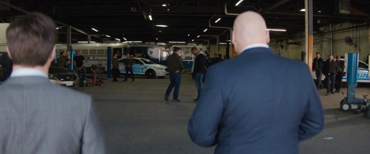 Fisk and Buck enter police garage.