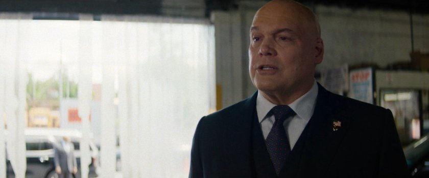 Fisk talking to plain clothes police officers in police garage.