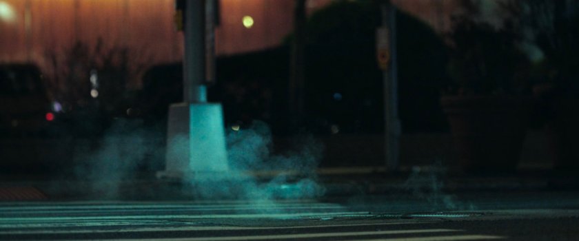 Interstitial: nighttime crosswalk with steaming manhole.