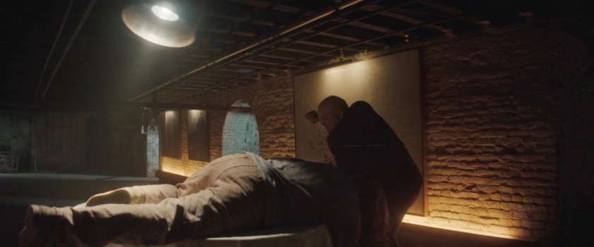 Fisk standing over unconscious Adam.