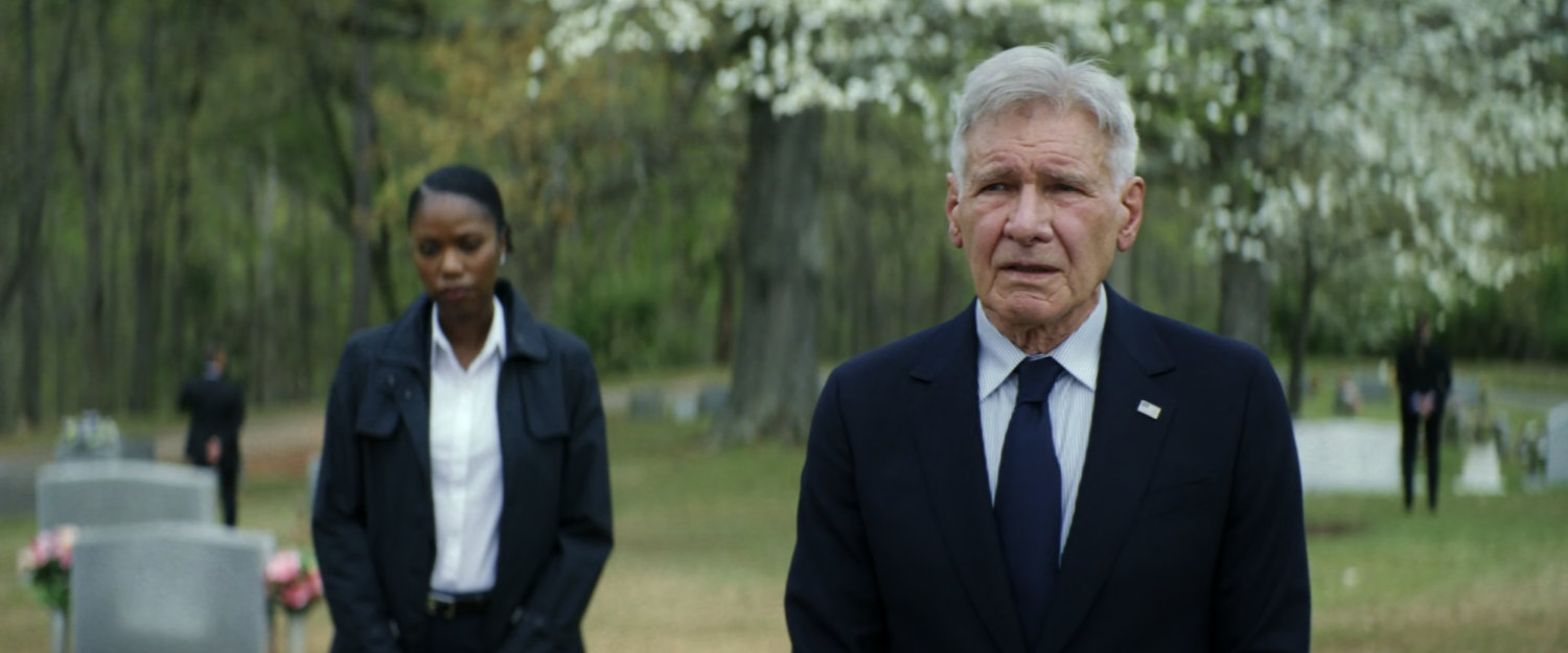 Agent Taylor and President Ross in a cemetery.