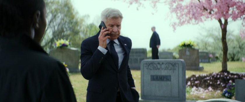Agent Taylor and President Ross in a cemetery.