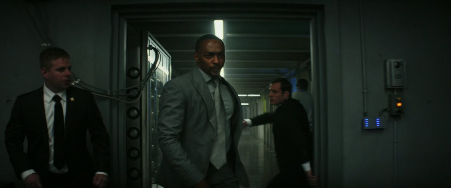 Sam pushes past Secret Service agents into the PEOC.