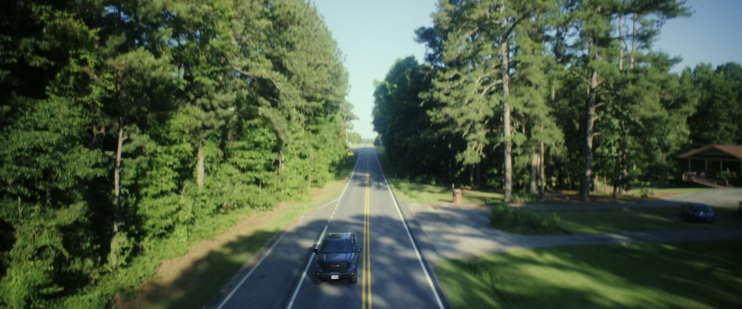 Sam driving on a road in Washington DC.