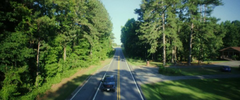 Sam driving on a road in Washington DC.
