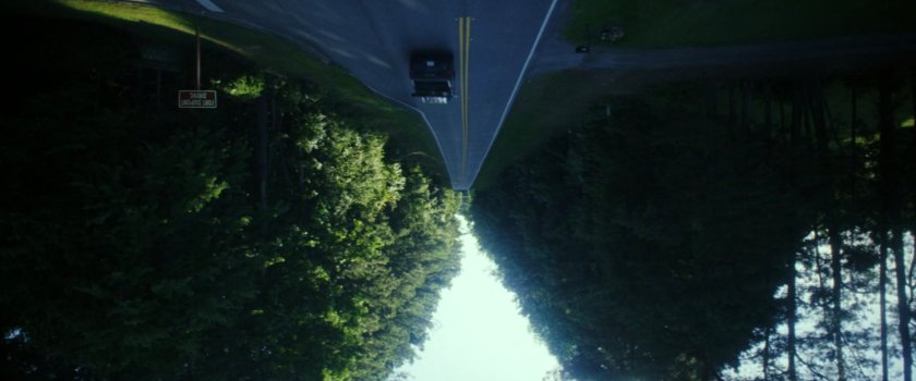 Inverted image of Sam driving on a road in Washington DC.