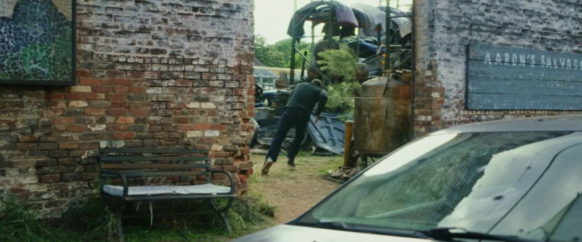 Sam running into Aaron's Salvage yard.