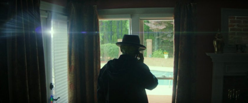 Samuel Sterns on the phone in a residential house.