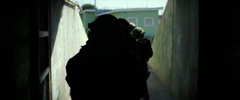 Military squad in tunnel at Navy training facility.