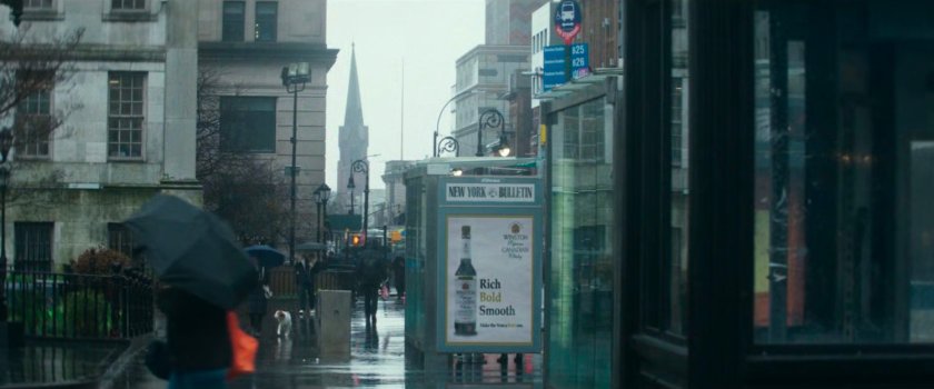 Interstitial: rainy sidewalk with church spire in distance.