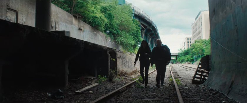 Detectives Kim & Flynn enter train tunnel that leads to Muse's lair.