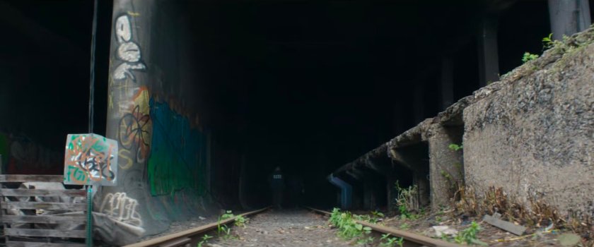 Detectives Kim & Flynn enter train tunnel that leads to Muse's lair.