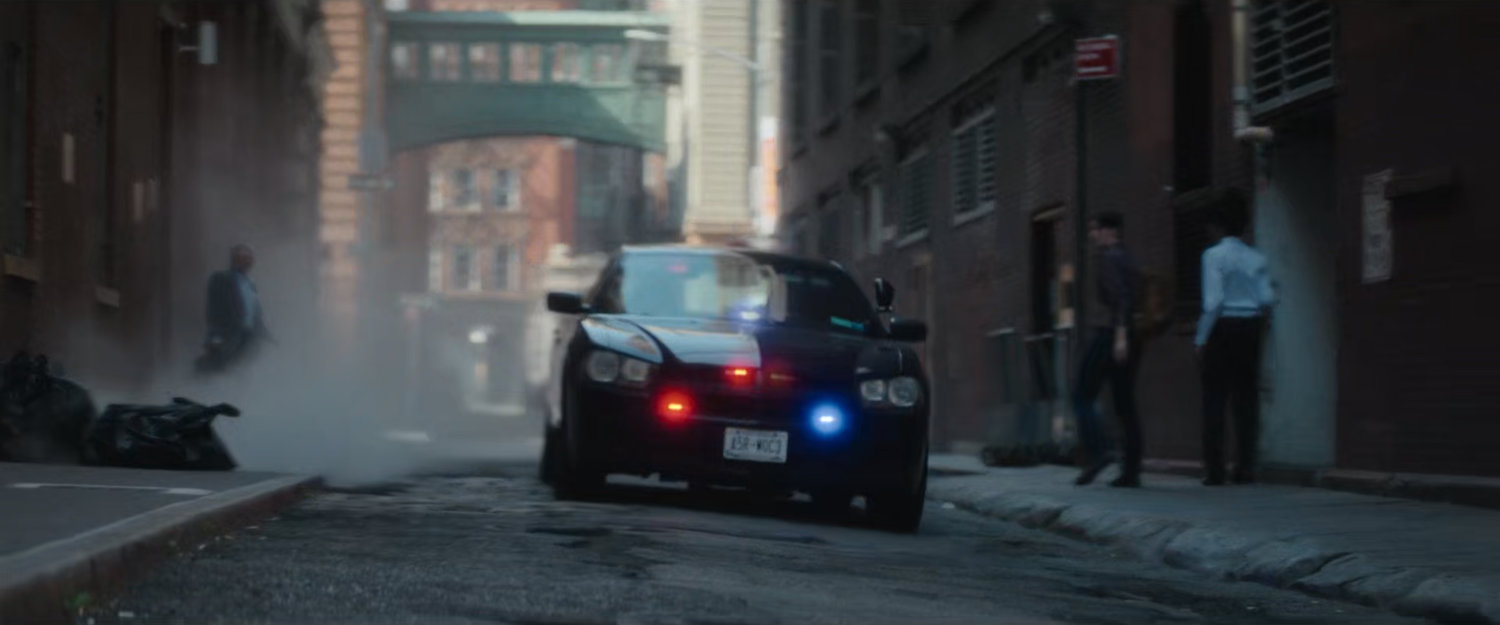 Police car driving through alley near Heather's office.