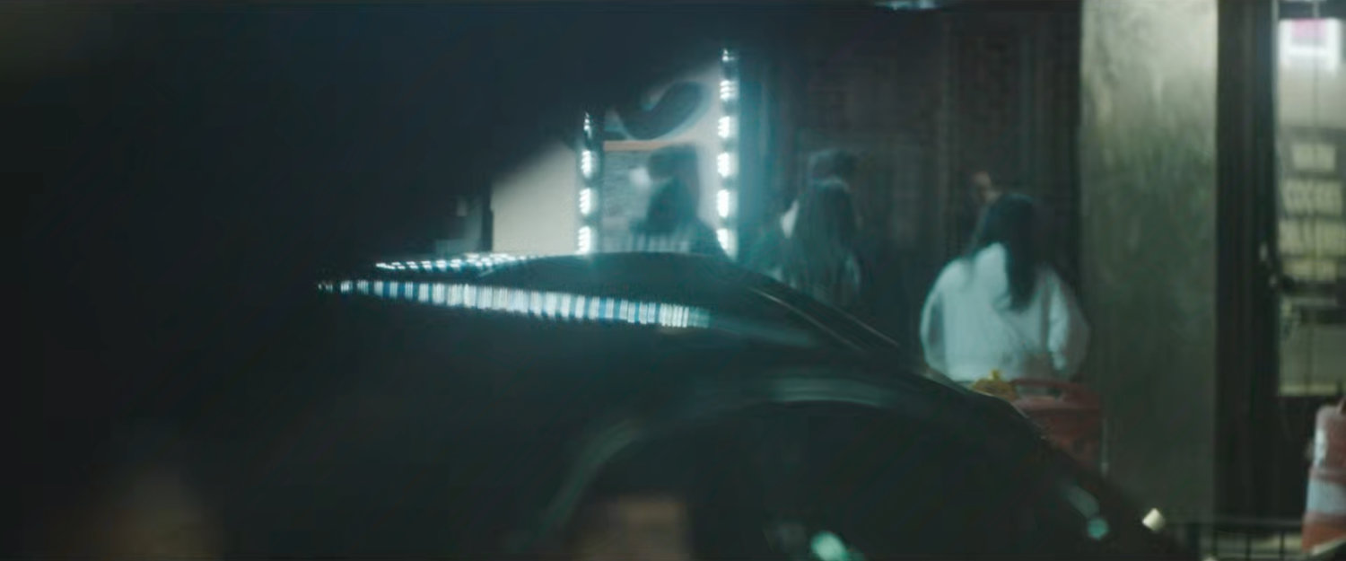 Interstitial: deep focus of pedestrians across street with traffic crossing.