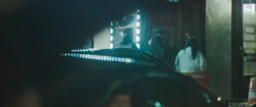 Interstitial: deep focus of pedestrians across street with traffic crossing.