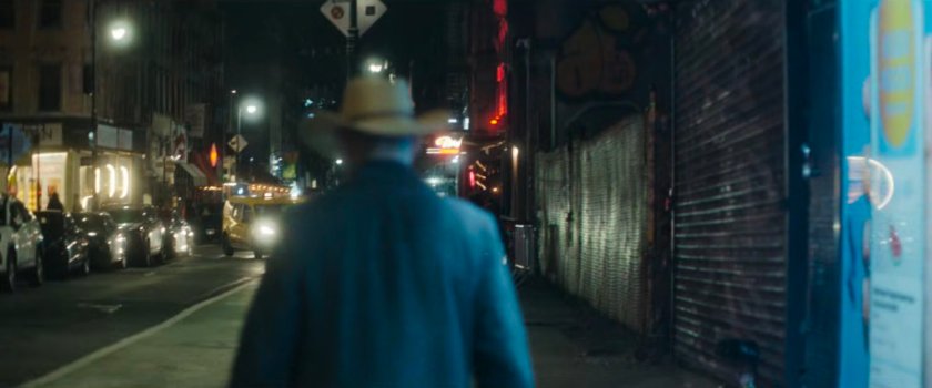 Interstitial: man walking along dark sidewalk.