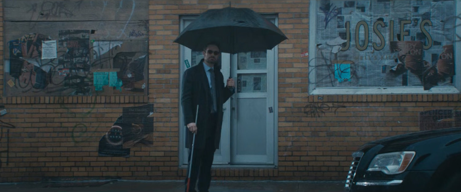 Matt with an umbrella outside Josie's bar.