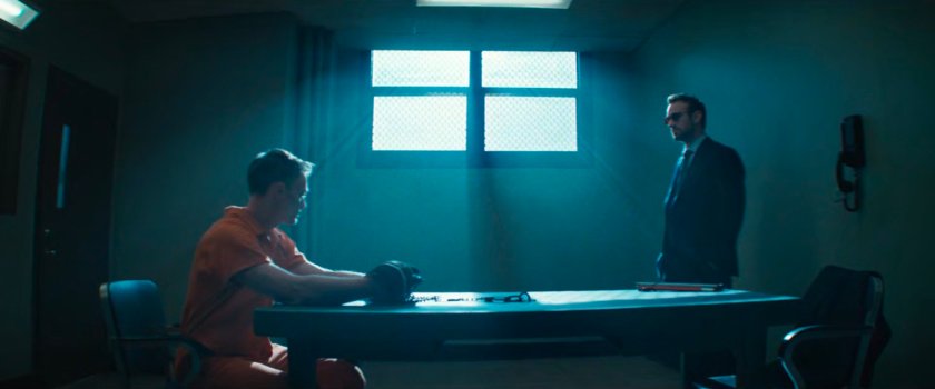 Dex and Matt in a visitor room at Ryker's Island Penitentiary.