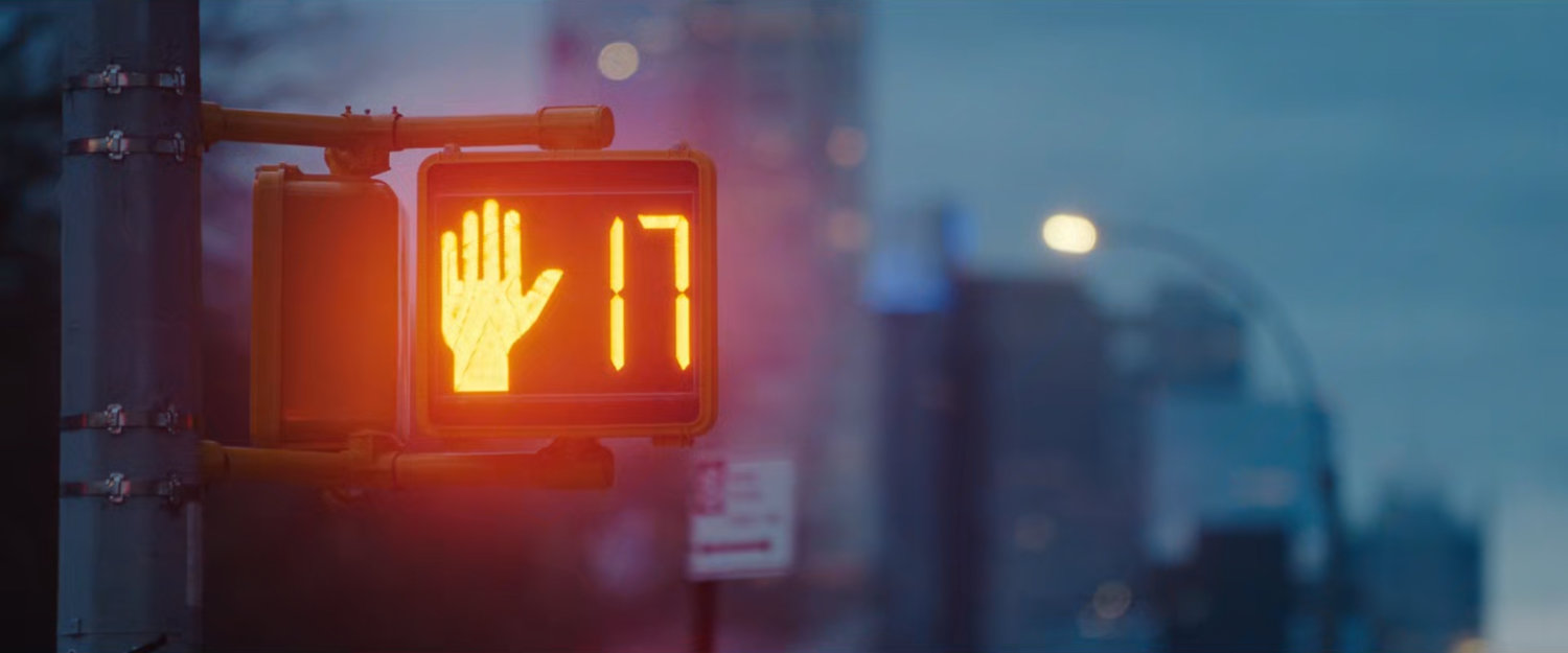Interstitial: a crosswalk signal at dusk.
