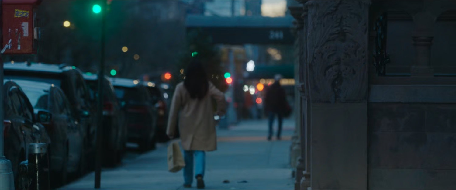 Interstitial: woman walking along sidewalk.